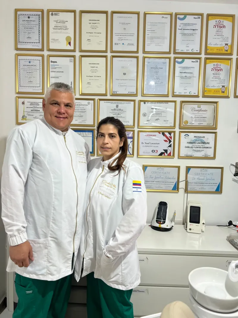 Dr. Yosef Lacouture Schmucker and Dr. Hannah Lacouture in front of their diplomas and certificates